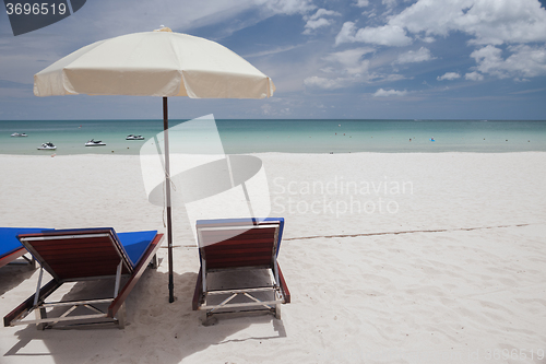 Image of Beach on tropical island. Clear blue water, sand, clouds. 