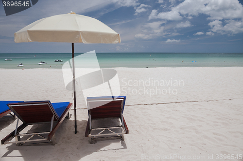 Image of Beach on tropical island. Clear blue water, sand, clouds. 