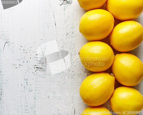 Image of fresh ripe lemons on wooden table