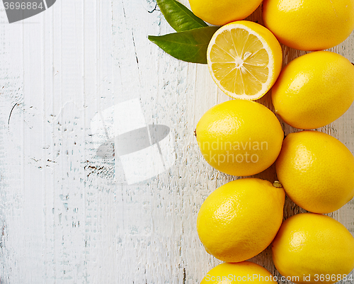 Image of fresh ripe lemons on wooden table