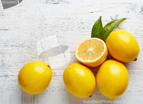 Image of fresh ripe lemons on wooden table