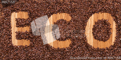 Image of The inscription ECO from flax seeds on the wooden table