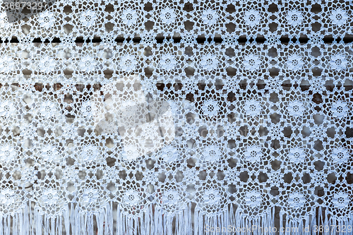 Image of white woven lace patterned tablecloth