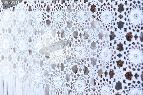 Image of white woven lace patterned tablecloth