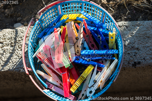 Image of colored plastic clothespins in a basket