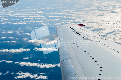 Image of Passenger Plane flies over clouds