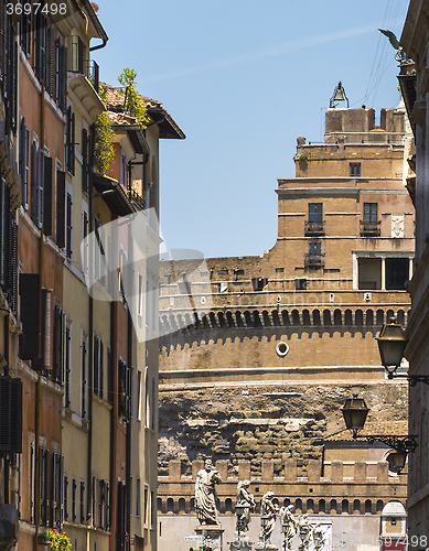 Image of Castle of the Holy Angel through buildings