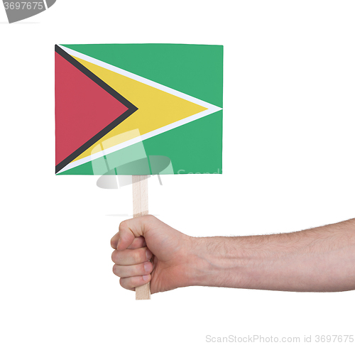 Image of Hand holding small card - Flag of Guyana