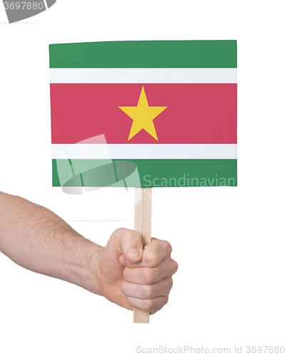 Image of Hand holding small card - Flag of Suriname