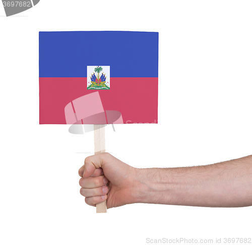 Image of Hand holding small card - Flag of Haiti