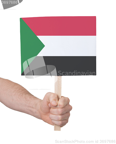 Image of Hand holding small card - Flag of Sudan