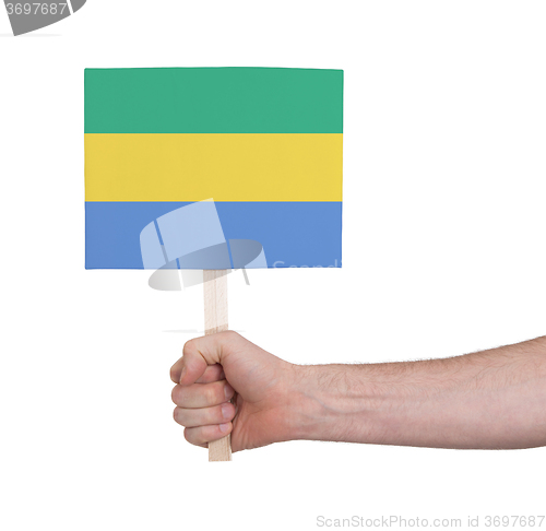 Image of Hand holding small card - Flag of Gabon
