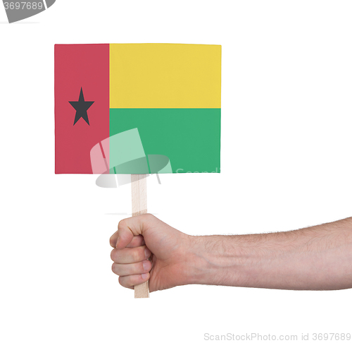Image of Hand holding small card - Flag of Guinea Bissau