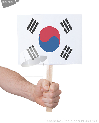 Image of Hand holding small card - Flag of South Korea