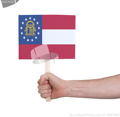 Image of Hand holding small card - Flag of Georgia