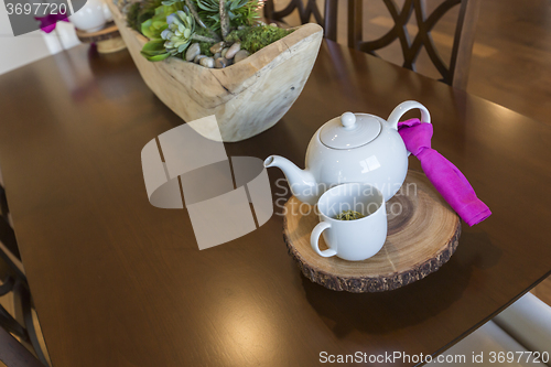 Image of Abstract of Inviting Table Setting with Tea and Kettle