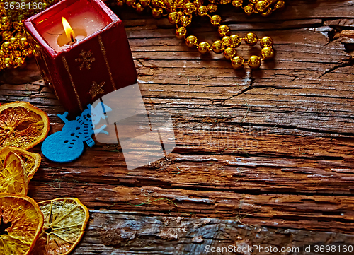 Image of Seasonal rustic Christmas border composed of ornaments over a wooden background with copyspace, overhead view