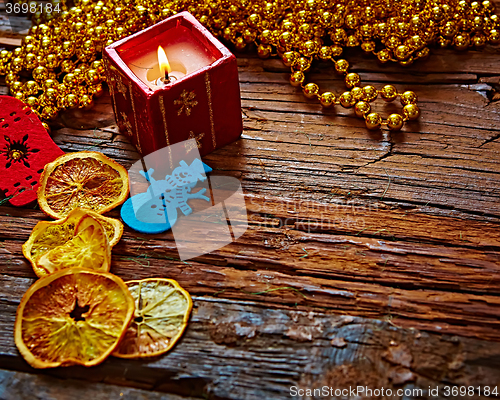 Image of Seasonal rustic Christmas border composed of ornaments over a wooden background with copyspace, overhead view