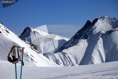 Image of Ski mask on ski poles and off-piste slope