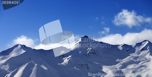 Image of Panoramic view on snowy sunlight mountains