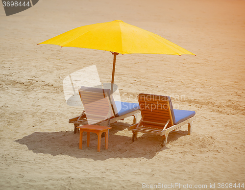 Image of Two chairs on a tropical beach