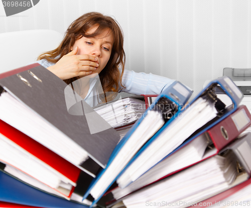 Image of Cute but tired young accountant