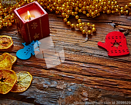 Image of Seasonal rustic Christmas border composed of ornaments over a wooden background with copyspace, overhead view