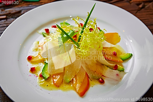 Image of salad of celery, avocado and persimmon with greens 