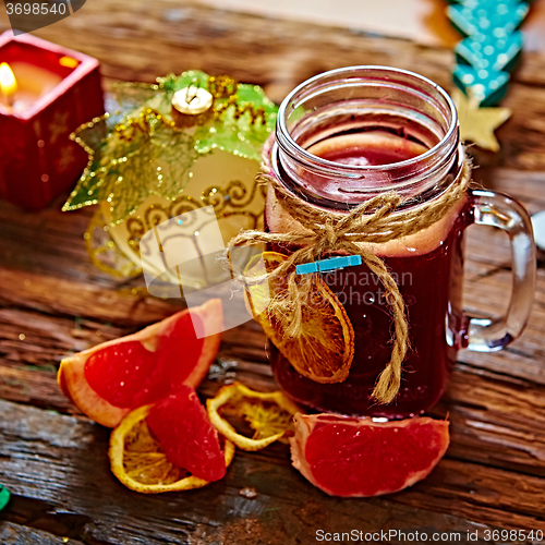 Image of Mulled wine and spices on wooden background. 