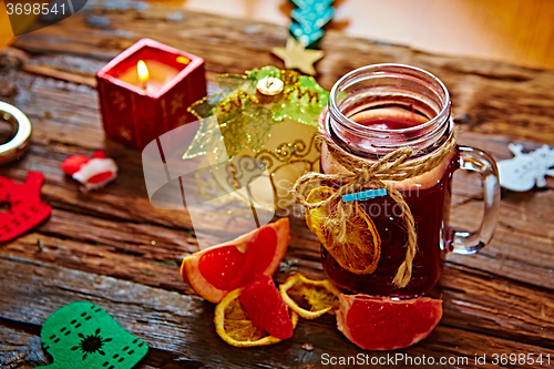 Image of Mulled wine and spices on wooden background. 