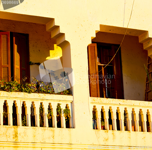 Image of   yellow window in morocco africa old construction and brown wal