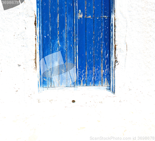 Image of blue door in antique village santorini greece europe and    whit
