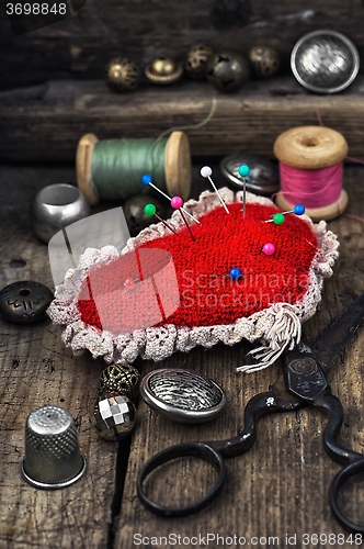 Image of pin cushion and sewing tools