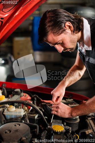 Image of Auto mechanic fixing car engine