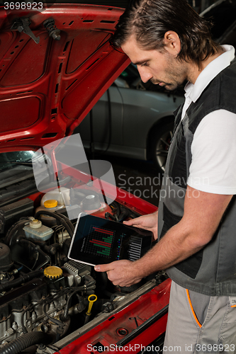 Image of Car mechanic using digital tablet
