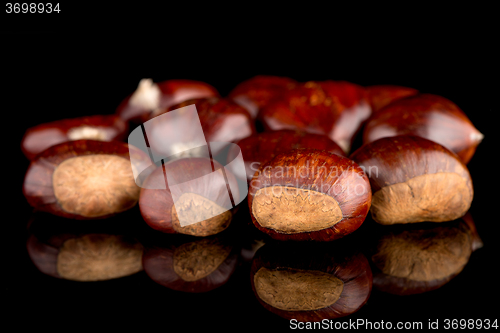 Image of Chestnuts on a black reflective background