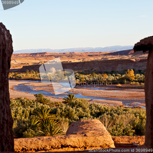 Image of sunset in africa old construction near the river blue