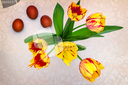 Image of Bouquet yellow tulips and Easter eggs.