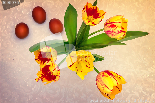 Image of Bouquet yellow tulips and Easter eggs.
