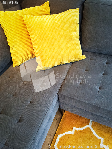Image of Gray sofa with yellow cushions