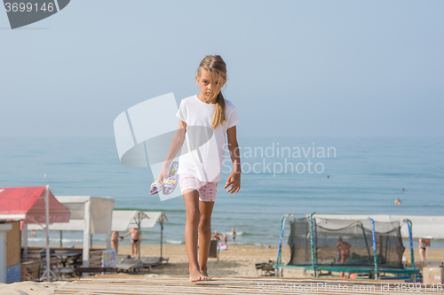 Image of Six year old girl walking on wooden flooring from the sea home