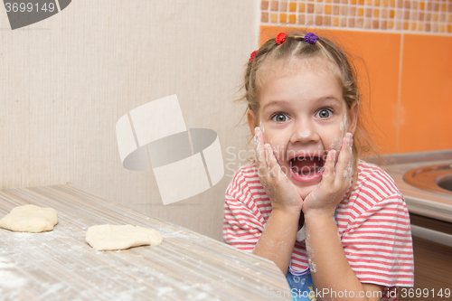 Image of Cheerful girl mired in agony with his mouth open looking into the frame