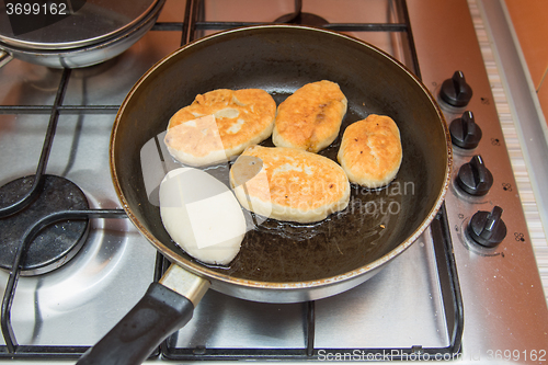 Image of Homemade cakes are fried in a skillet