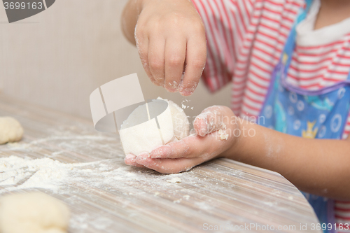 Image of Girl floured pastry stuck together