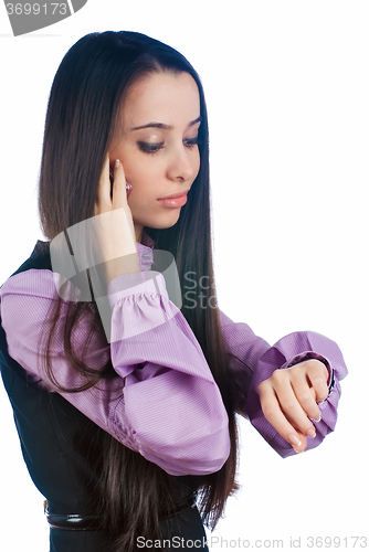 Image of Attractive woman talks on phone and looks on watch