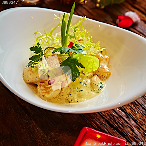 Image of griled chicken breasts in pesto souse