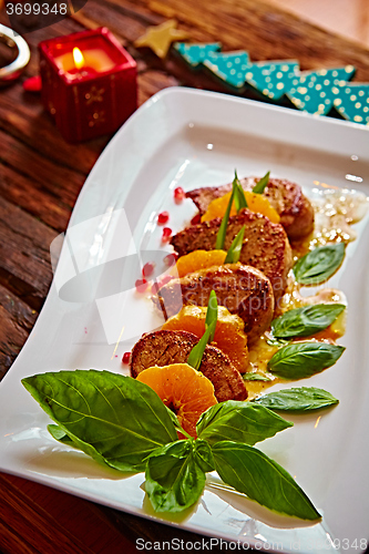 Image of Grilled pork with mandarin oranges decorated and basil 