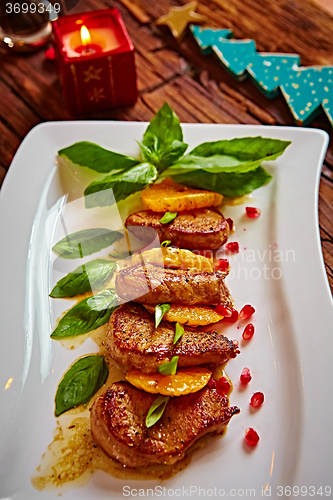 Image of Grilled pork with mandarin oranges decorated and basil 