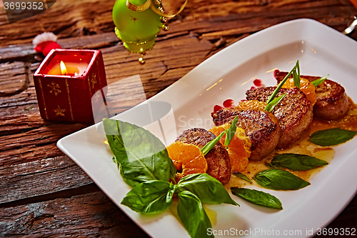 Image of Grilled pork with mandarin oranges decorated and basil 