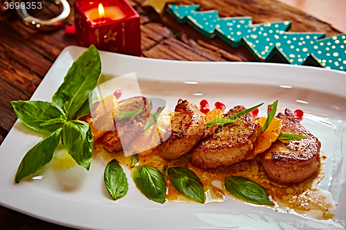 Image of Grilled pork with mandarin oranges decorated and basil 